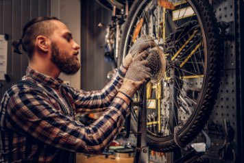 person servising a bike